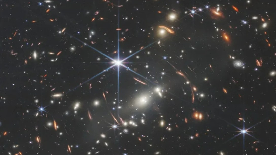 A field of distance galaxies with a bright star in the foreground
