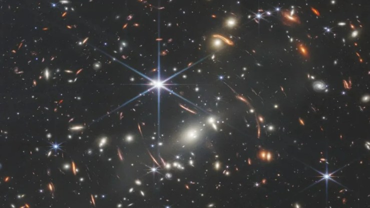 A field of distance galaxies with a bright star in the foreground
